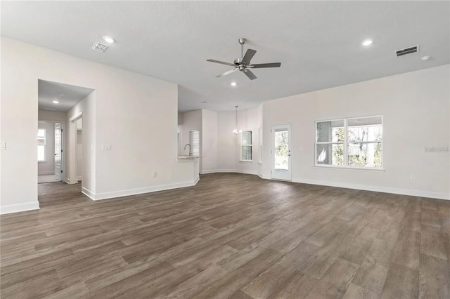 21 Uniondale Pl, Palm Coast, FL 32164 - unfurnished living room with dark wood-style floors, visible vents, a ceiling fan, and recessed lighting