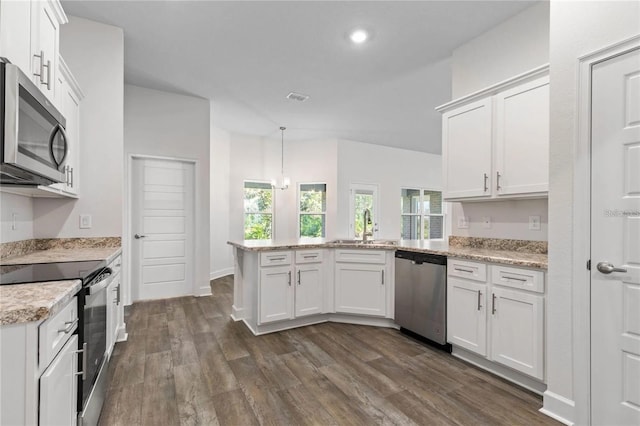 21 Uniondale Pl, Palm Coast, FL 32164 - kitchen with white cabinetry, stainless steel appliances, a peninsula, and a sink