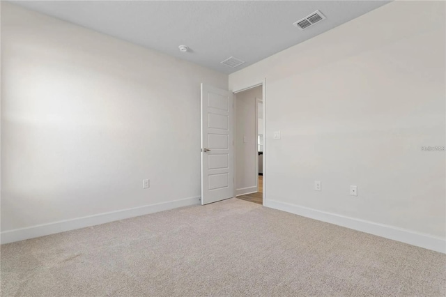 21 Uniondale Pl, Palm Coast, FL 32164 - spare room with baseboards, visible vents, and light colored carpet