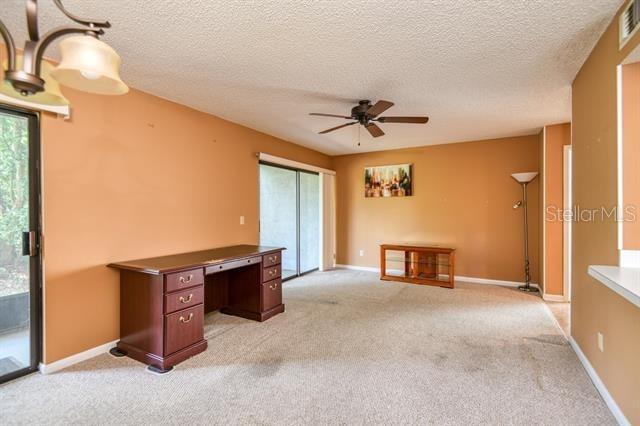 27 Catalonia Ct Unit A, Saint Augustine, FL 32086 - unfurnished office with a textured ceiling, ceiling fan, and light carpet