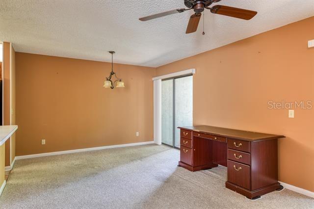 27 Catalonia Ct Unit A, Saint Augustine, FL 32086 - unfurnished office featuring light colored carpet, a textured ceiling, baseboards, and ceiling fan