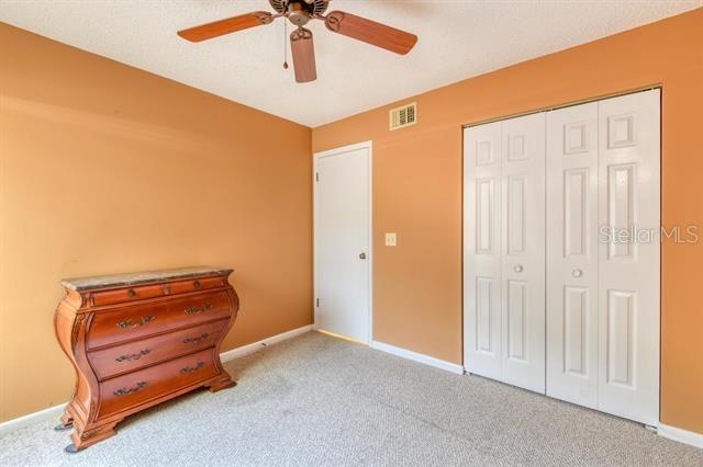 27 Catalonia Ct Unit A, Saint Augustine, FL 32086 - carpeted bedroom with baseboards, a closet, and visible vents