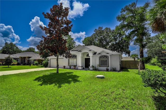 ranch-style house with driveway, a garage, fence, a front lawn, and stucco siding