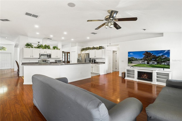living room featuring visible vents and dark wood finished floors