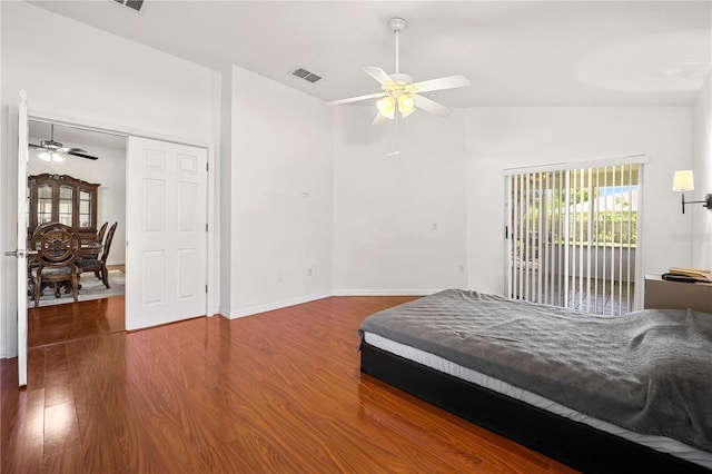 bedroom featuring access to outside, high vaulted ceiling, a ceiling fan, wood finished floors, and visible vents