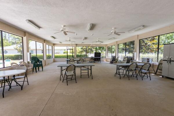 125 Raintree Cir, Palm Coast, FL 32164 - sunroom featuring outdoor dining space, ceiling fan, and a textured ceiling