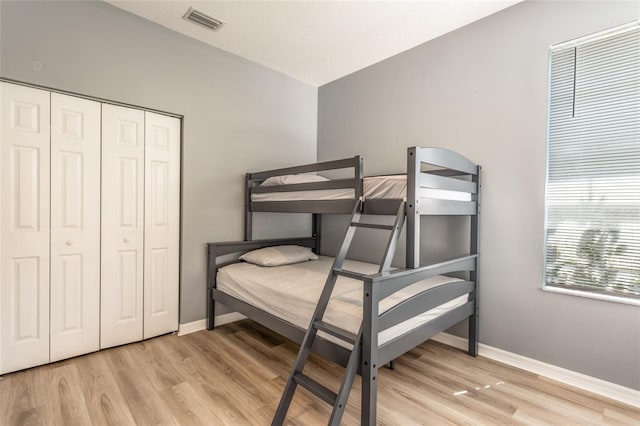 125 Raintree Cir, Palm Coast, FL 32164 - bedroom with baseboards, light wood-style floors, and visible vents