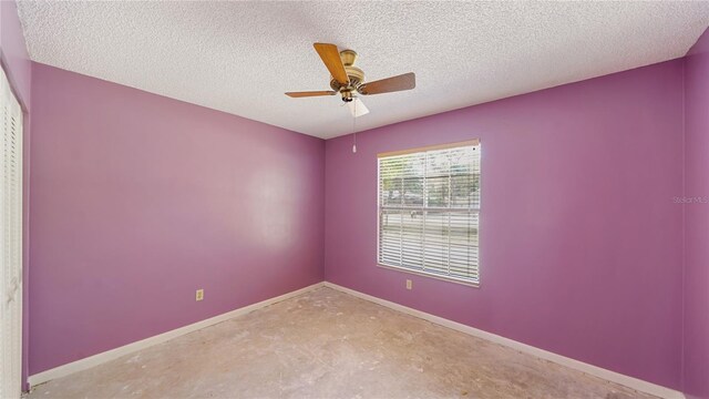 689 16th St, Saint Augustine, FL 32080 - empty room featuring concrete flooring, a ceiling fan, baseboards, and a textured ceiling