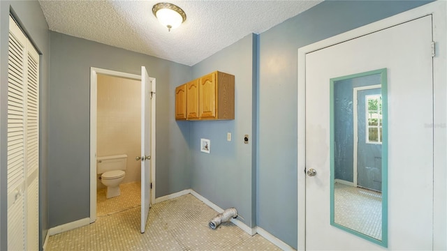 689 16th St, Saint Augustine, FL 32080 - washroom with cabinet space, hookup for a washing machine, baseboards, a textured ceiling, and light tile patterned floors
