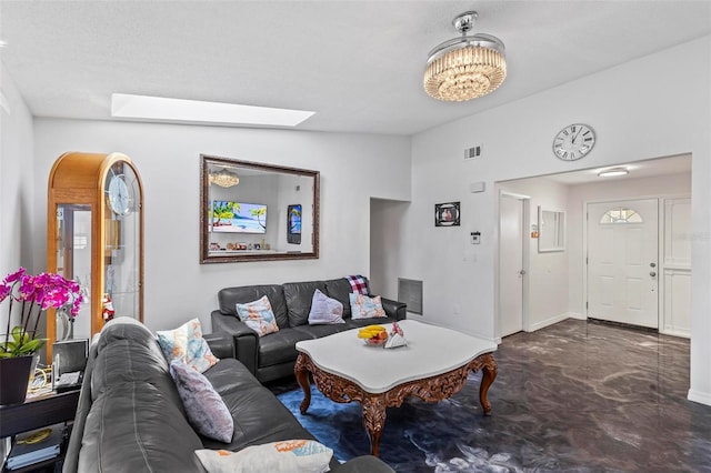 13 Belleaire Dr, Palm Coast, FL 32137 - living area with an inviting chandelier, baseboards, lofted ceiling with skylight, and visible vents