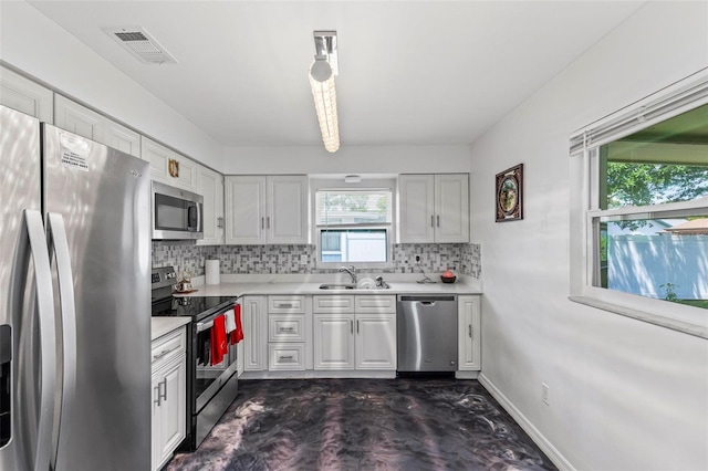 13 Belleaire Dr, Palm Coast, FL 32137 - kitchen with backsplash, appliances with stainless steel finishes, visible vents, and light countertops