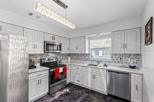 13 Belleaire Dr, Palm Coast, FL 32137 - kitchen featuring a sink, appliances with stainless steel finishes, white cabinetry, and visible vents
