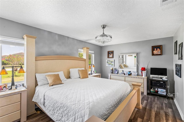 13 Belleaire Dr, Palm Coast, FL 32137 - bedroom featuring a textured ceiling, visible vents, and dark wood-type flooring