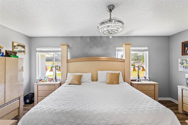13 Belleaire Dr, Palm Coast, FL 32137 - bedroom with dark wood-style flooring, a textured ceiling, and baseboards