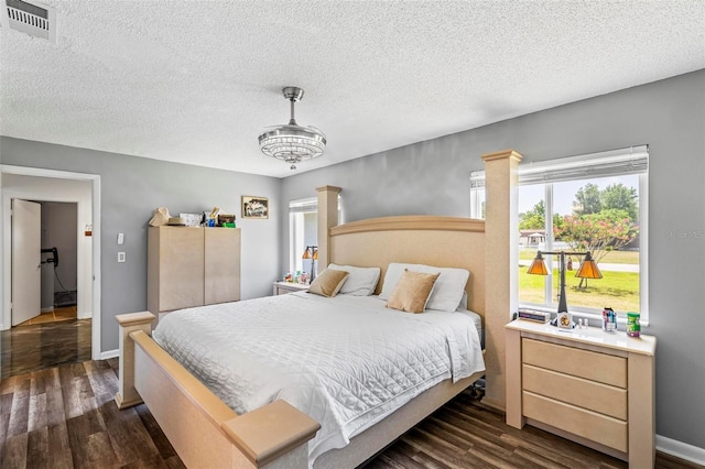 13 Belleaire Dr, Palm Coast, FL 32137 - bedroom featuring visible vents, a textured ceiling, and dark wood-style flooring