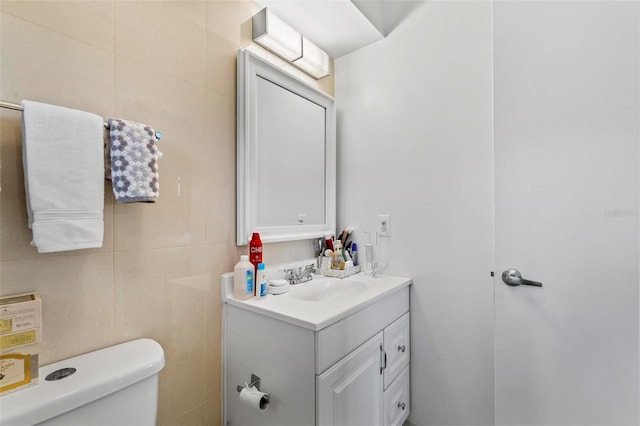 13 Belleaire Dr, Palm Coast, FL 32137 - bathroom featuring vanity, toilet, and tile walls