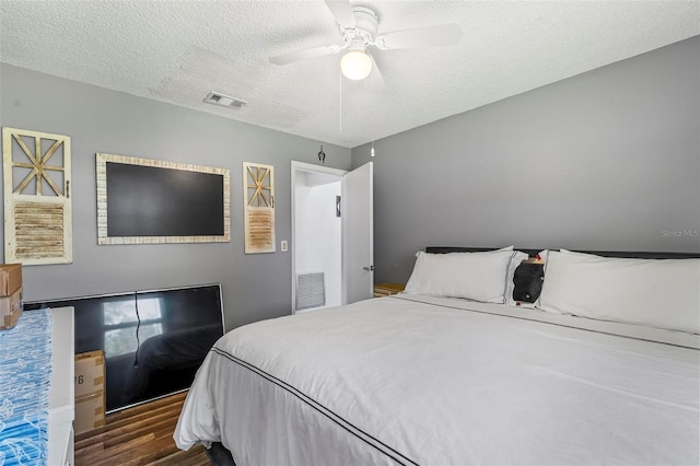 13 Belleaire Dr, Palm Coast, FL 32137 - bedroom featuring visible vents, a textured ceiling, ceiling fan, and wood finished floors