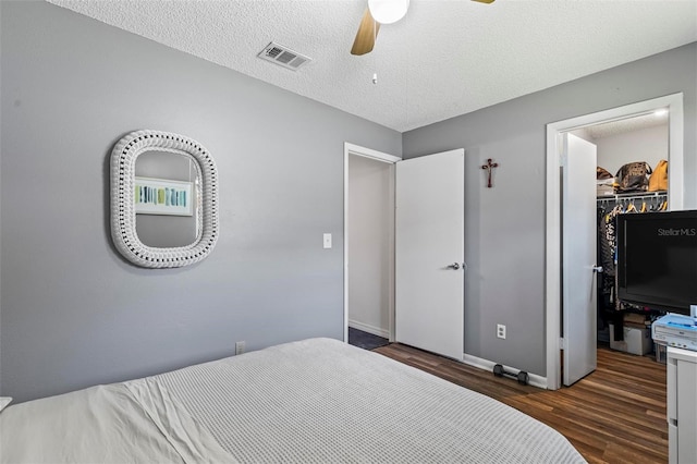 13 Belleaire Dr, Palm Coast, FL 32137 - bedroom with visible vents, a closet, baseboards, a walk in closet, and dark wood-type flooring
