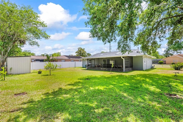 13 Belleaire Dr, Palm Coast, FL 32137 - view of yard featuring a sunroom, fence, an outbuilding, and a storage unit