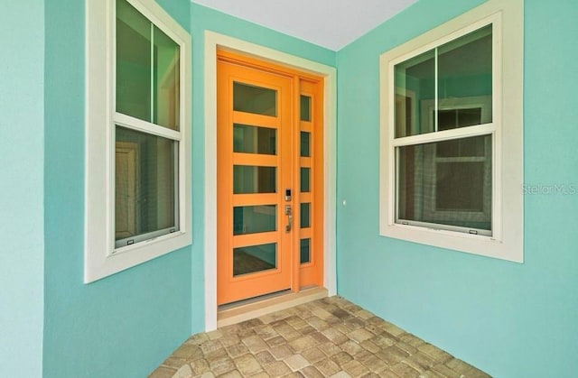 property entrance featuring stucco siding
