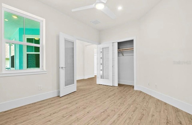 unfurnished bedroom with a ceiling fan, baseboards, wood finished floors, visible vents, and a closet
