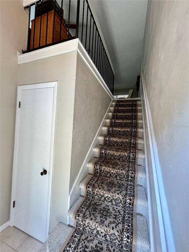 stairs featuring tile patterned floors