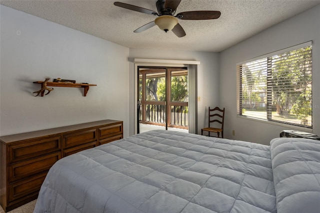 bedroom with access to outside, a ceiling fan, and a textured ceiling