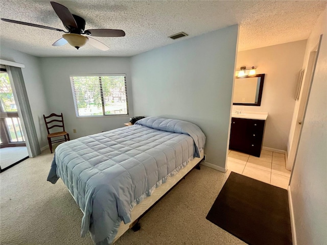 bedroom with visible vents, a textured ceiling, light carpet, and multiple windows