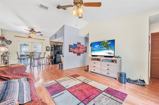living area featuring visible vents, a ceiling fan, and wood finished floors