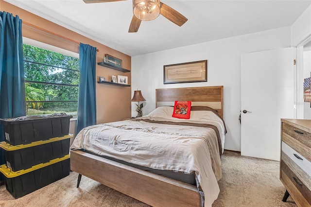 bedroom featuring a ceiling fan and light colored carpet