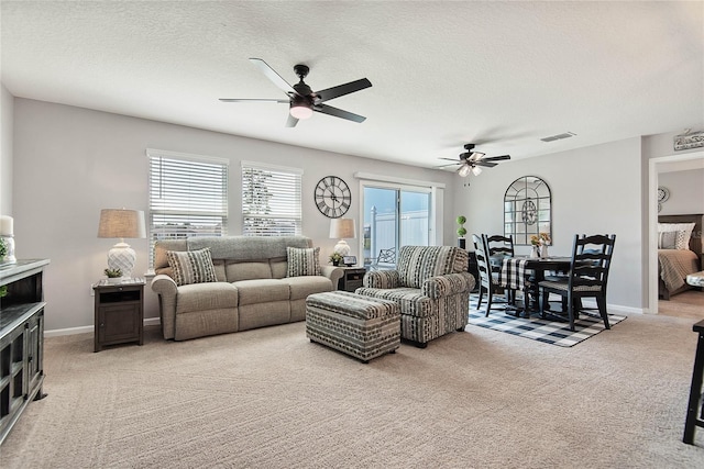 7 Windsor Ter, Palm Coast, FL 32164 - living room with a ceiling fan, visible vents, light carpet, and a wealth of natural light