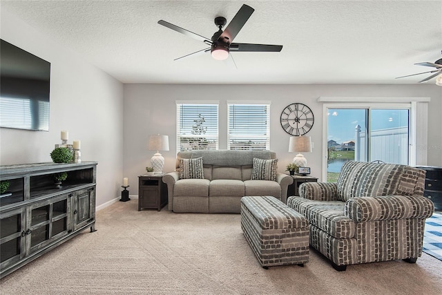 7 Windsor Ter, Palm Coast, FL 32164 - carpeted living room featuring a textured ceiling, ceiling fan, and a healthy amount of sunlight