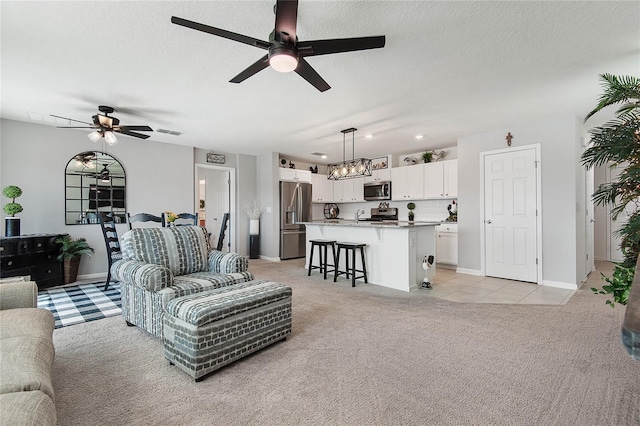 7 Windsor Ter, Palm Coast, FL 32164 - living room with light colored carpet, a textured ceiling, ceiling fan with notable chandelier, and light tile patterned flooring