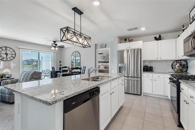 7 Windsor Ter, Palm Coast, FL 32164 - kitchen featuring ceiling fan, visible vents, a center island with sink, a sink, and stainless steel appliances