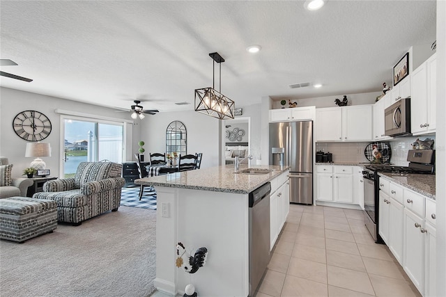 7 Windsor Ter, Palm Coast, FL 32164 - kitchen featuring appliances with stainless steel finishes, a ceiling fan, open floor plan, and visible vents