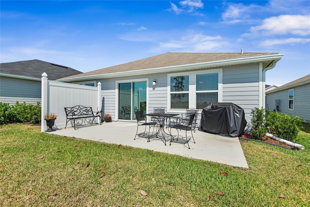 7 Windsor Ter, Palm Coast, FL 32164 - back of property featuring a lawn and a patio area