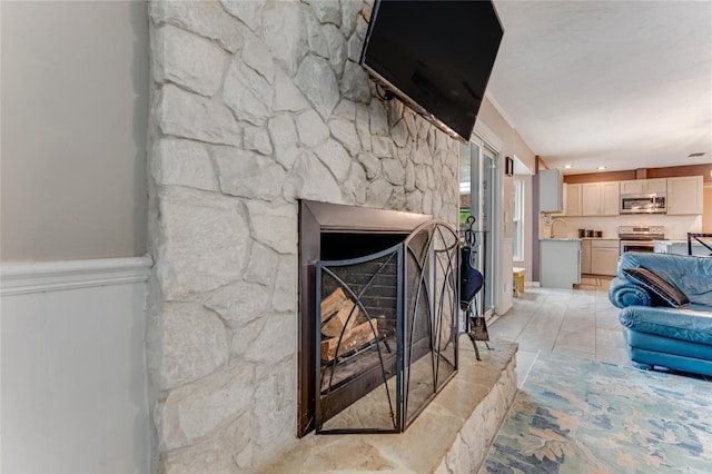 11 Larisa Ter, Ormond Beach, FL 32174 - living area featuring a fireplace with raised hearth, wainscoting, and a decorative wall