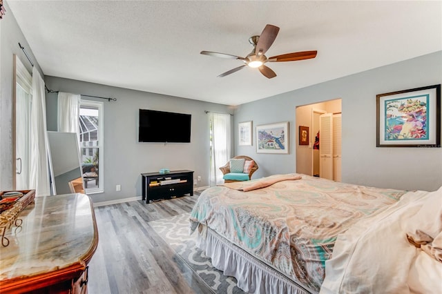 11 Larisa Ter, Ormond Beach, FL 32174 - bedroom featuring baseboards, ceiling fan, a textured ceiling, and wood finished floors