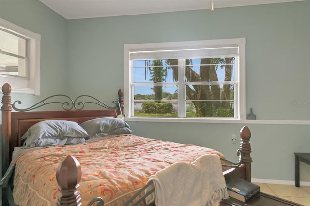 tiled bedroom featuring baseboards