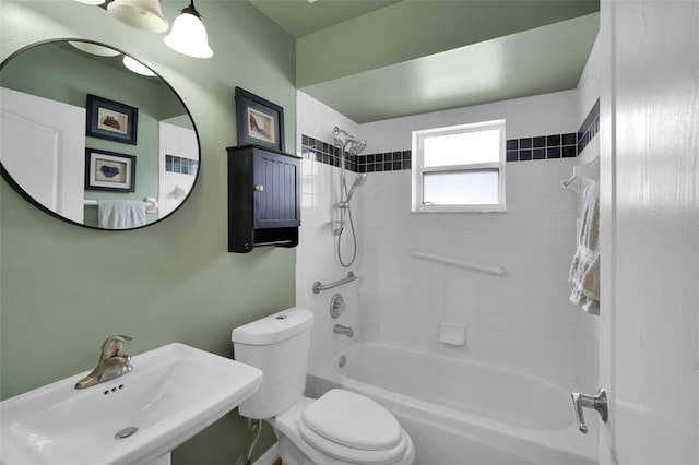 full bathroom featuring a sink, tub / shower combination, and toilet