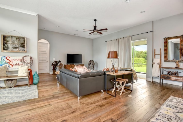 living room with arched walkways, ceiling fan, recessed lighting, and hardwood / wood-style flooring
