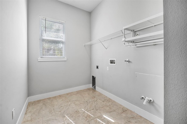 clothes washing area with laundry area, washer hookup, gas dryer hookup, baseboards, and hookup for an electric dryer