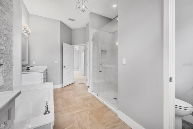 bathroom featuring visible vents, a stall shower, vanity, baseboards, and toilet