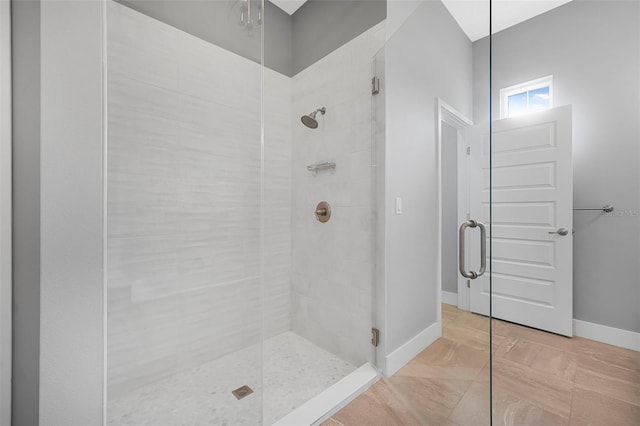 full bathroom with baseboards and a stall shower
