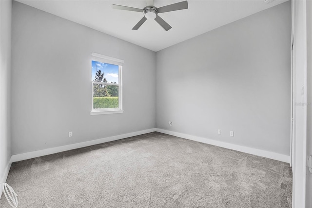 spare room featuring baseboards, carpet, and ceiling fan