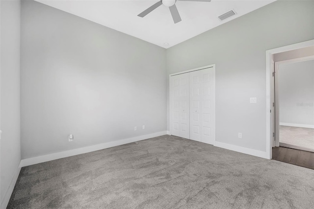 unfurnished bedroom with carpet, a ceiling fan, baseboards, visible vents, and a closet