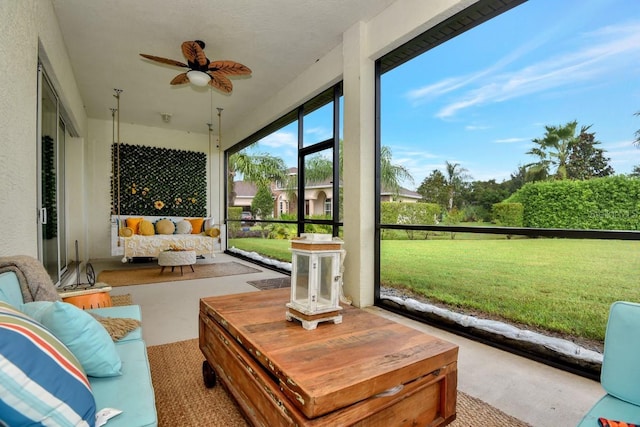 sunroom featuring a ceiling fan and carpet flooring
