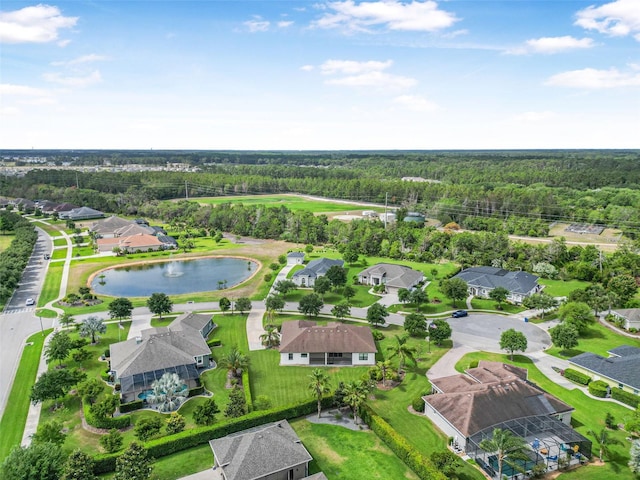 bird's eye view featuring a water view, a residential view, and a wooded view
