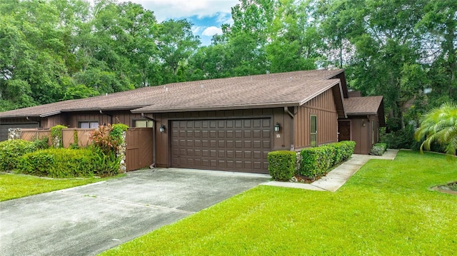 15 Morning Dew Trl, Ormond Beach, FL 32174 - view of front of home with a garage, a front lawn, concrete driveway, and roof with shingles