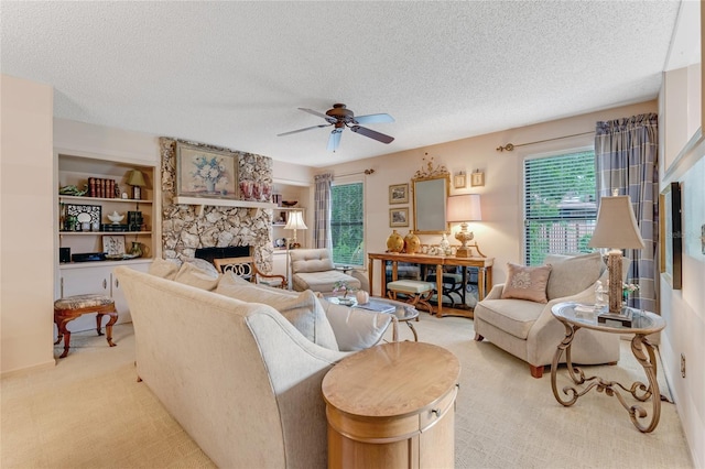 15 Morning Dew Trl, Ormond Beach, FL 32174 - living room featuring a fireplace, a textured ceiling, a ceiling fan, and light colored carpet